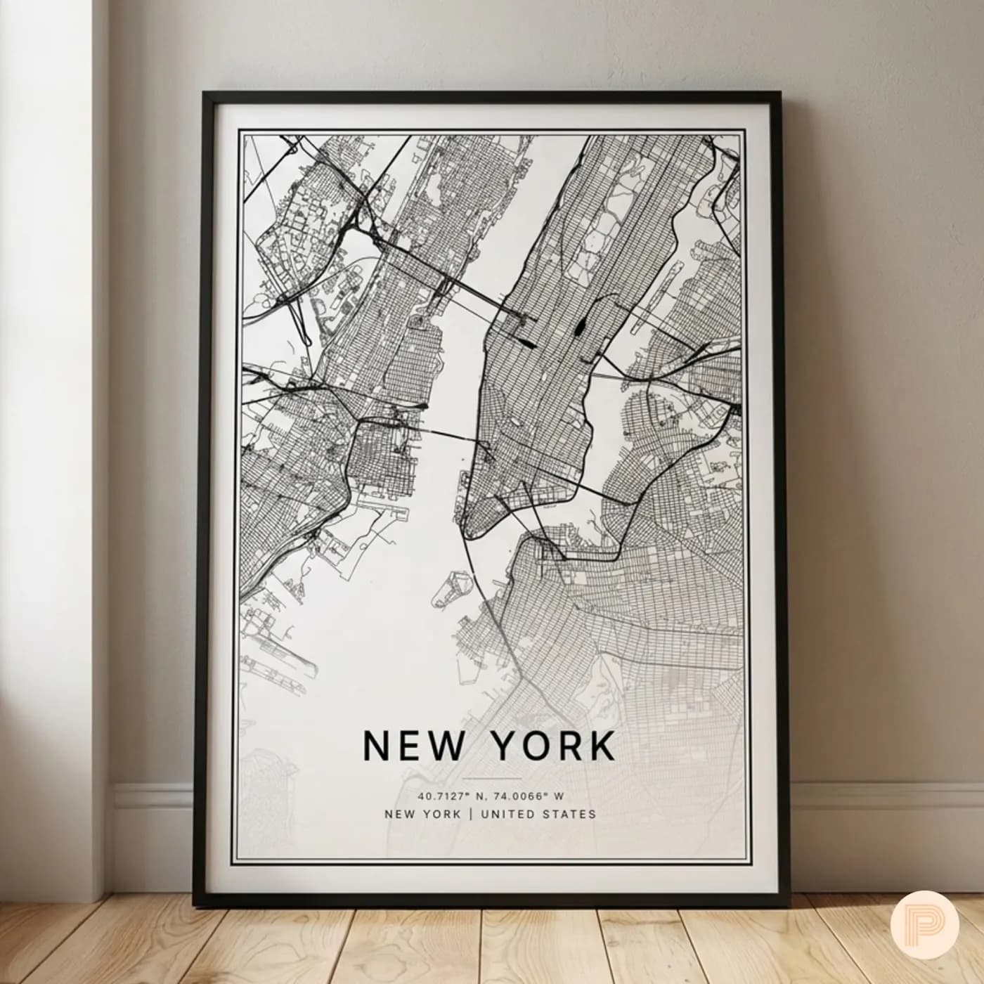 Black-and-white New York street map in a slim black frame, leaning on a wood floor against a beige wall